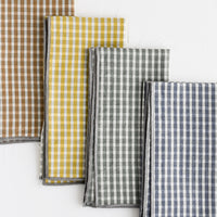 2: A set of four plaid print napkins in a mix of colors.