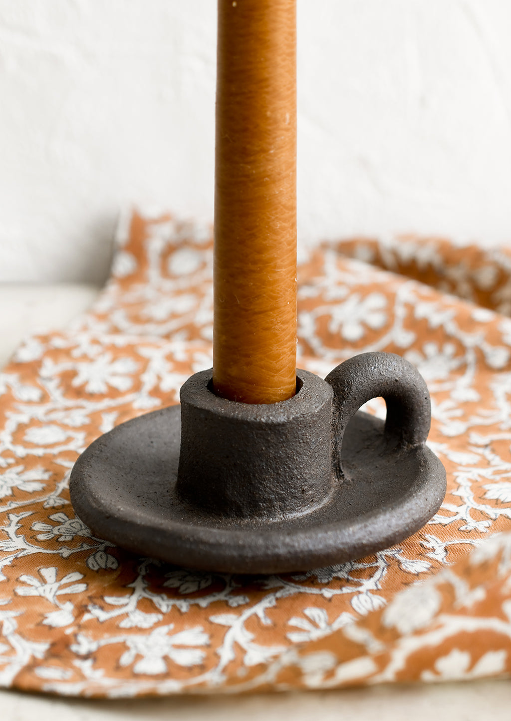 Dark: A ceramic taper holder in dark brown clay.