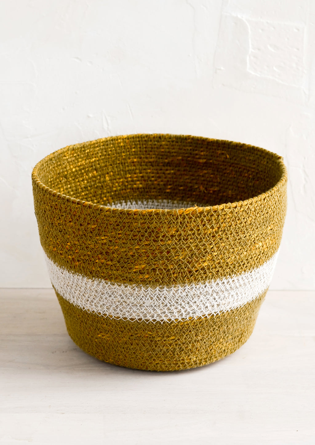 Large / Ochre: A round seagrass storage basket in ochre color with white stripe across middle.