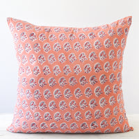 1: A square block printed pillow with a pink, grey, and red floral design.