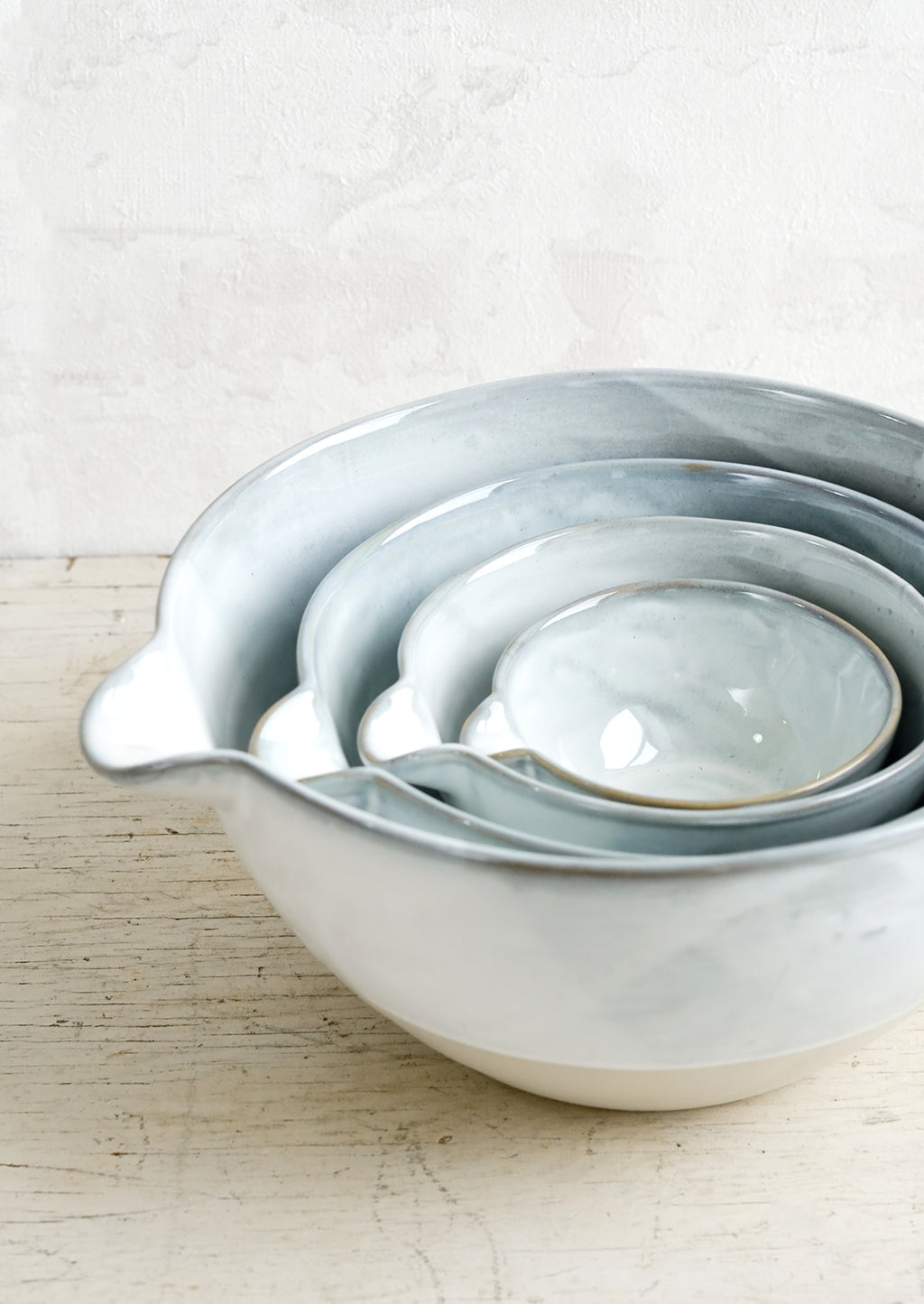 2: Four nesting ceramic bowls with pouring spouts.