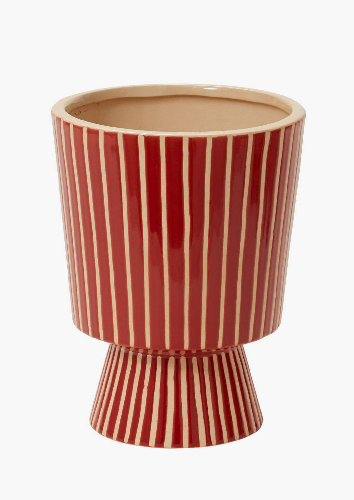A footed planter with vertical white stripes on red ceramic.