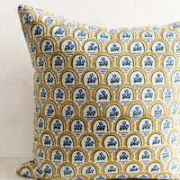 3: A block printed pillow with yellow and blue floral motif.