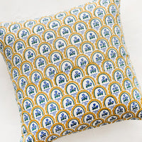 1: A block printed pillow with yellow and blue floral motif.