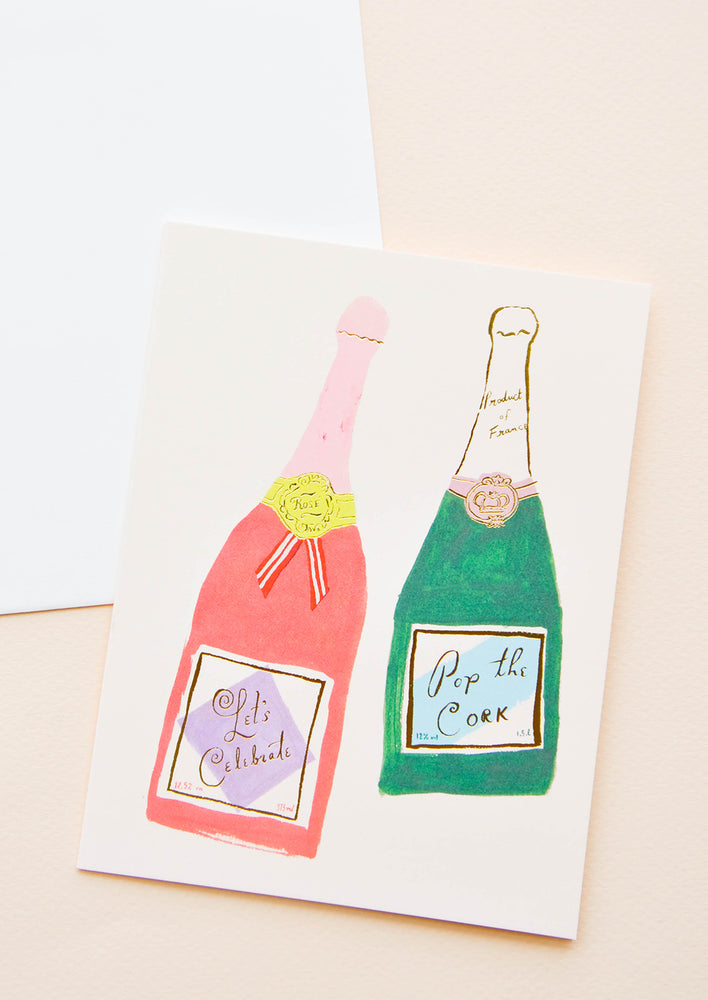 1: A greeting card with illustration of two bottles of champagne.