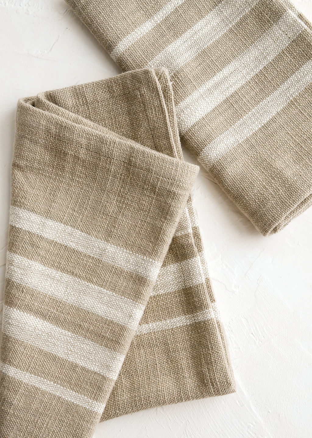 Tan / Ivory (Partial Stripe): A pair of folded napkins in tan with ivory stripes.