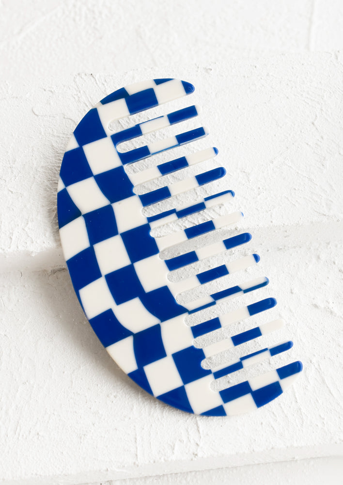 A curved comb in blue and white checker print.