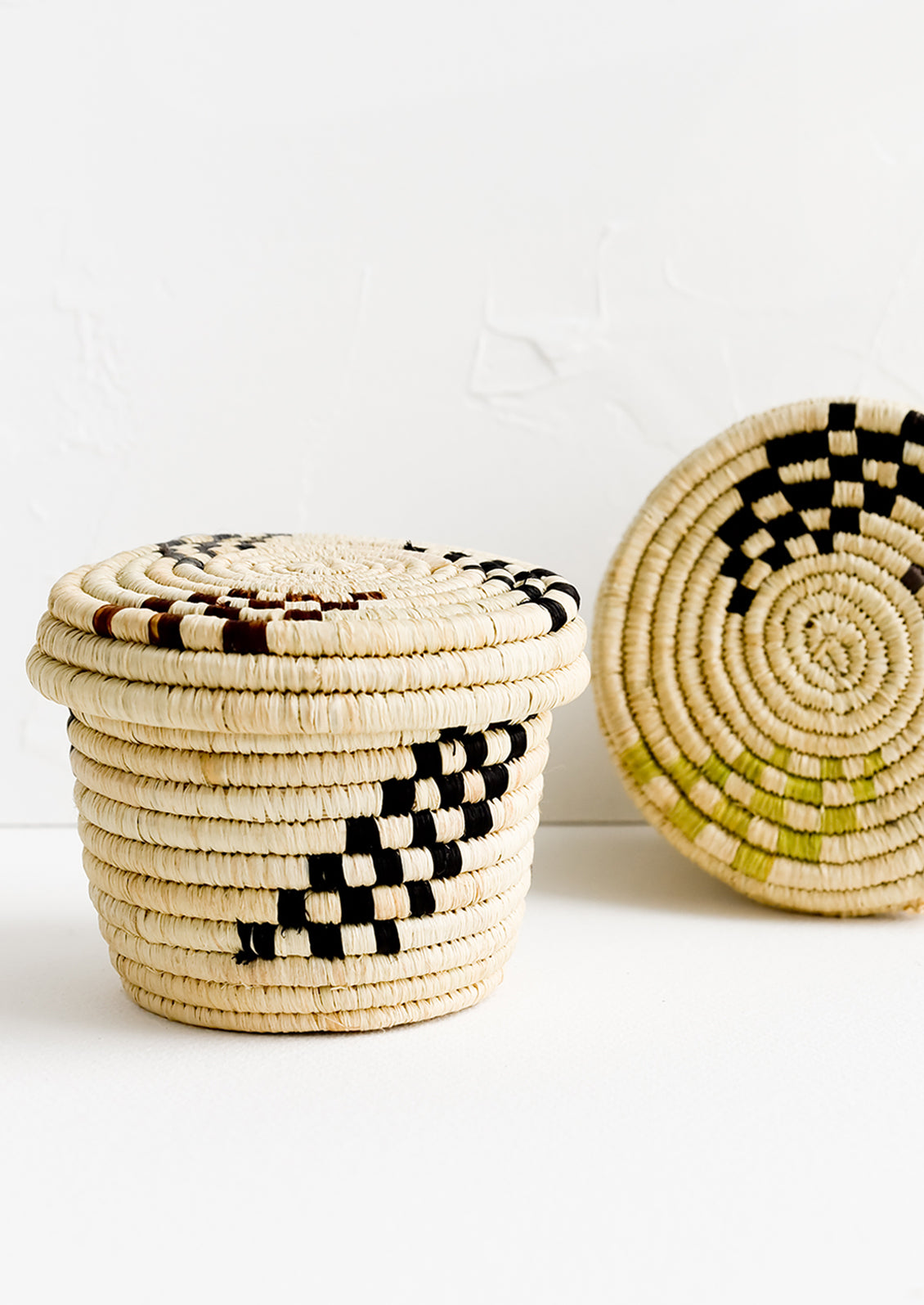 Small raffia baskets in woven checker print.