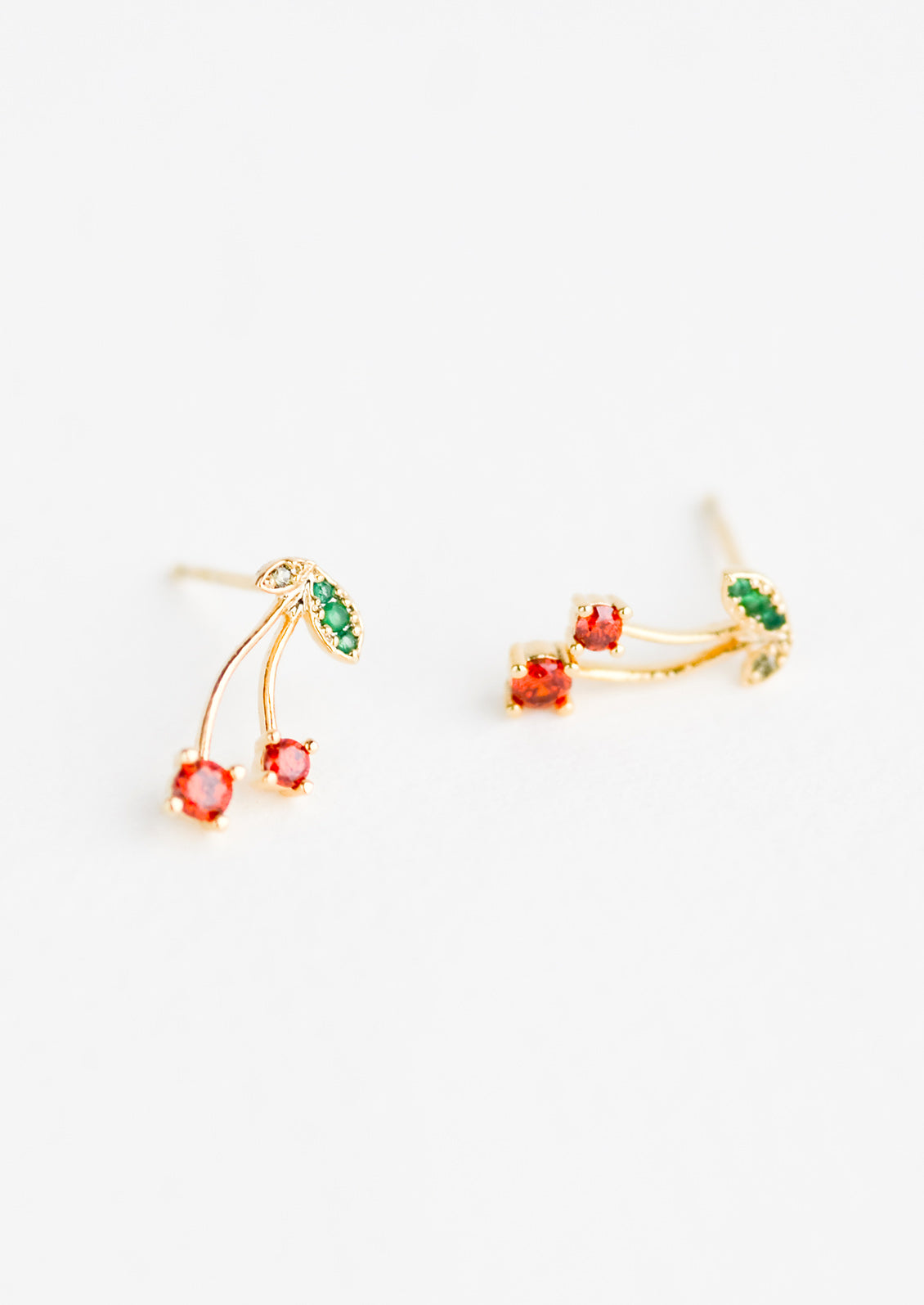 A pair of gold stud earrings in cherry design.
