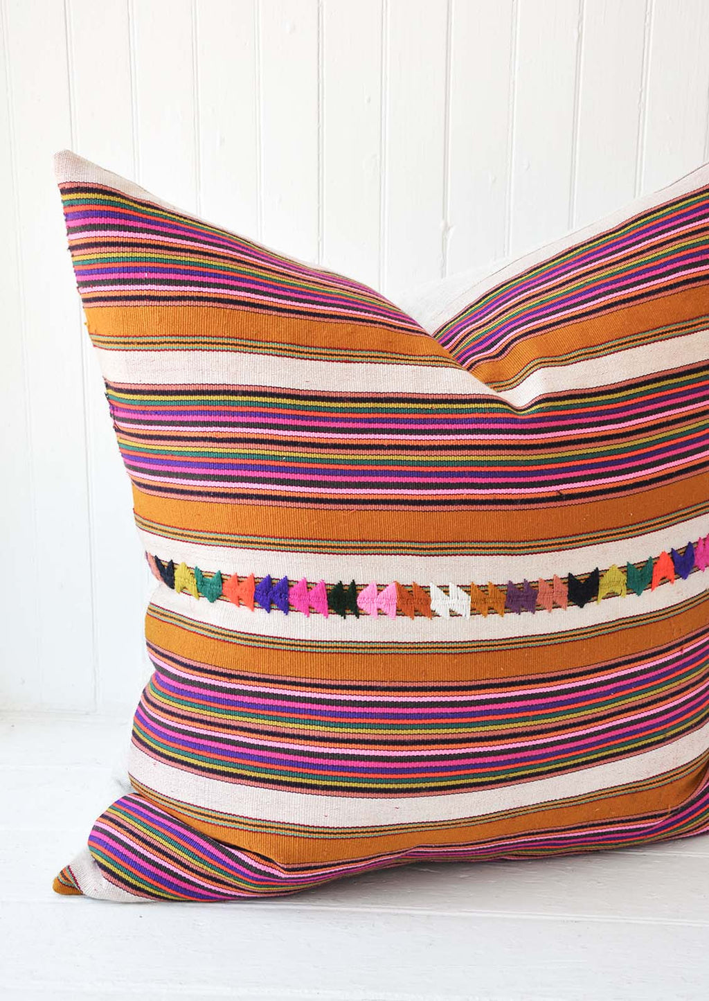 3: A multi-colored stripe pillow.