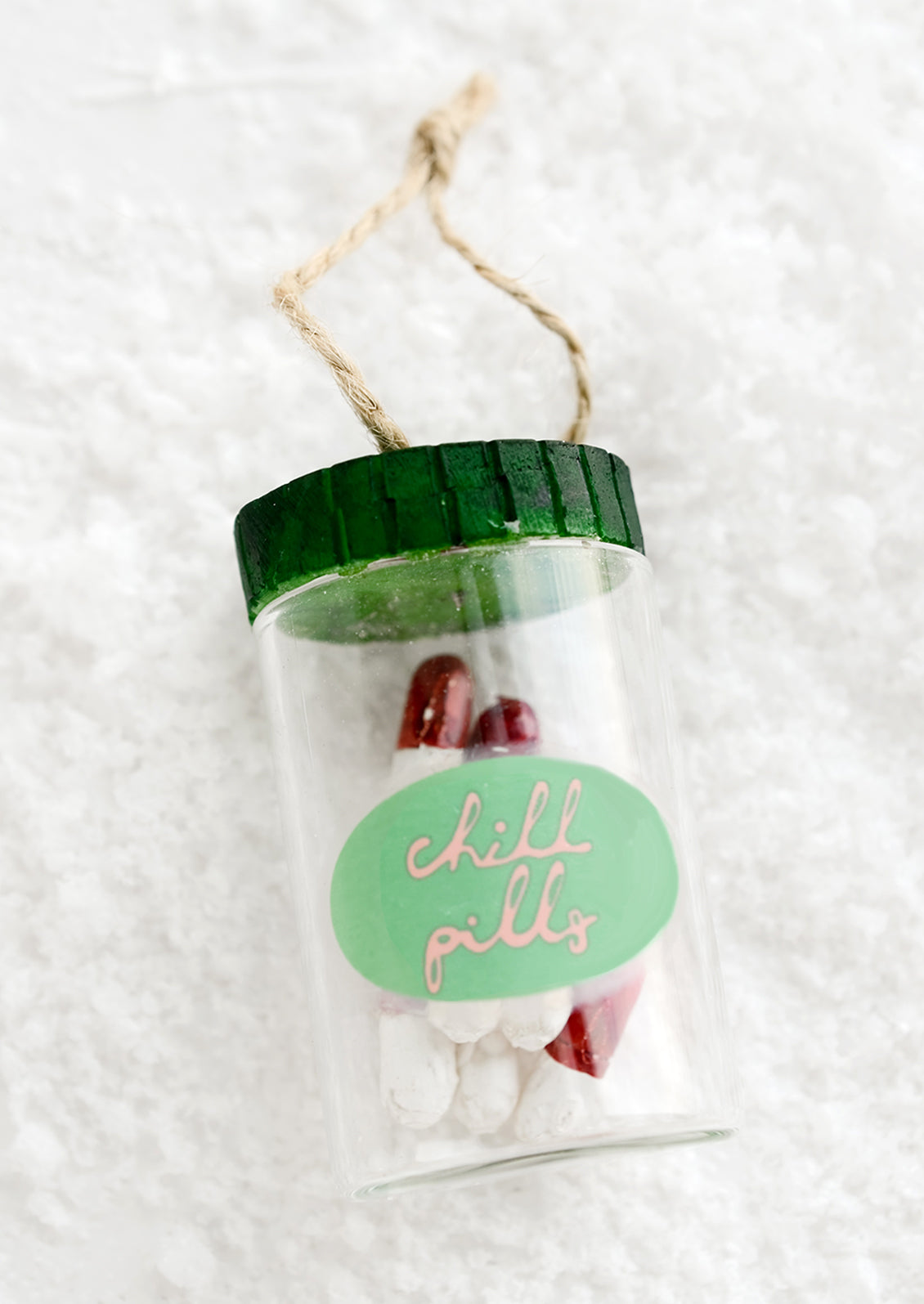 Holiday ornament made to look like a pill bottle containing red and white pills with label reading "chill pills".
