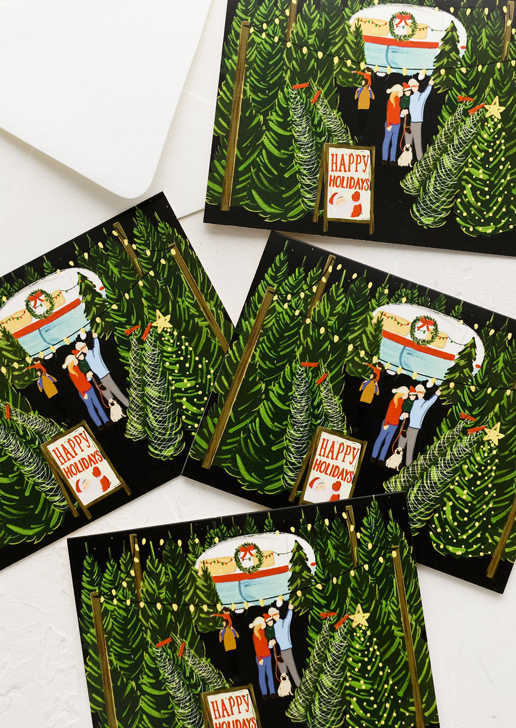 Boxed Set of 8: A set of cards with illustration of family shopping for a Christmas tree.