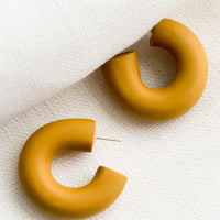 Dulce: A pair of polymer clay hoop earrings in dulce brown.
