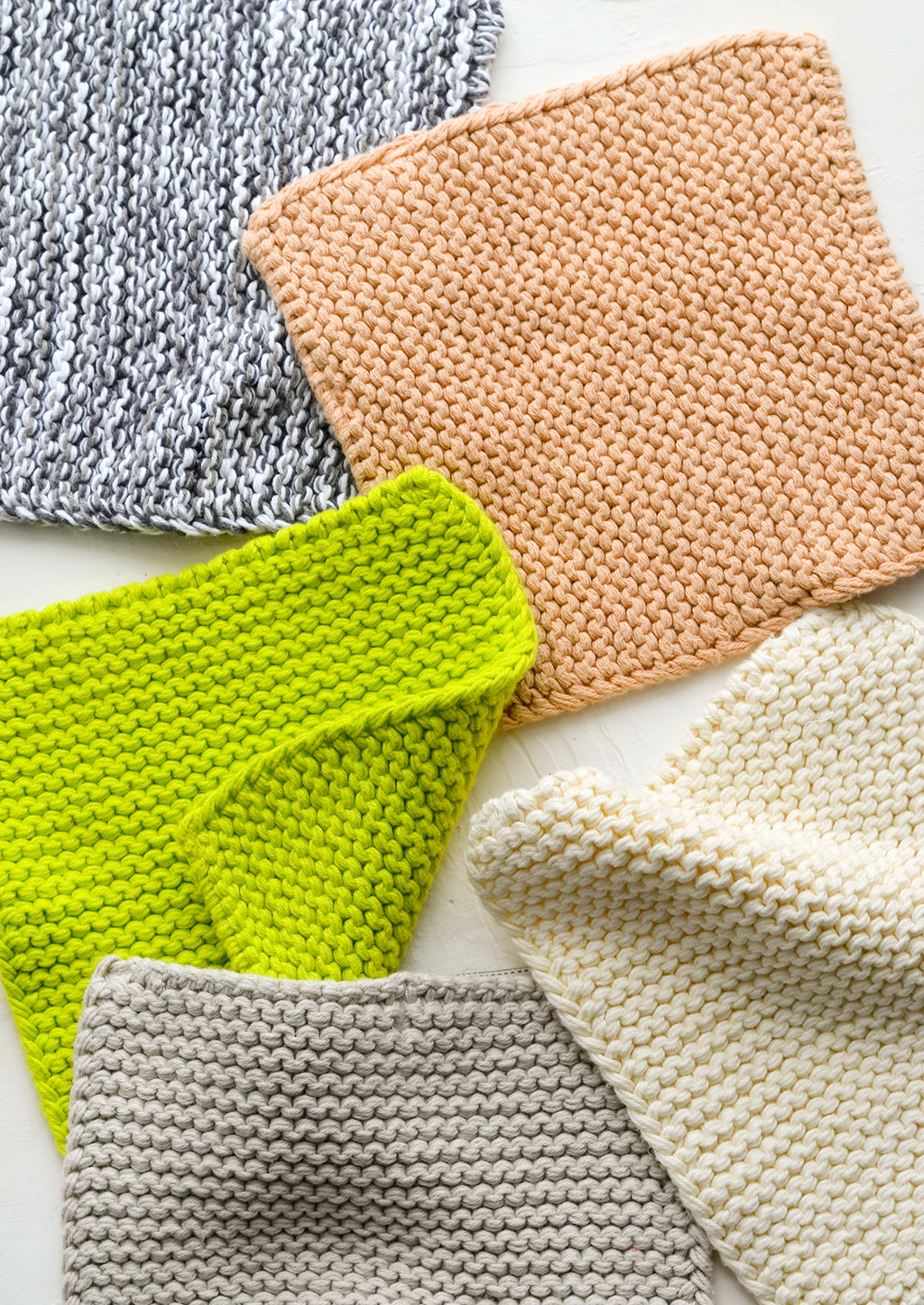 2: Chunky knit potholder squares in assorted colors.