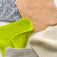2: Chunky knit potholder squares in assorted colors.