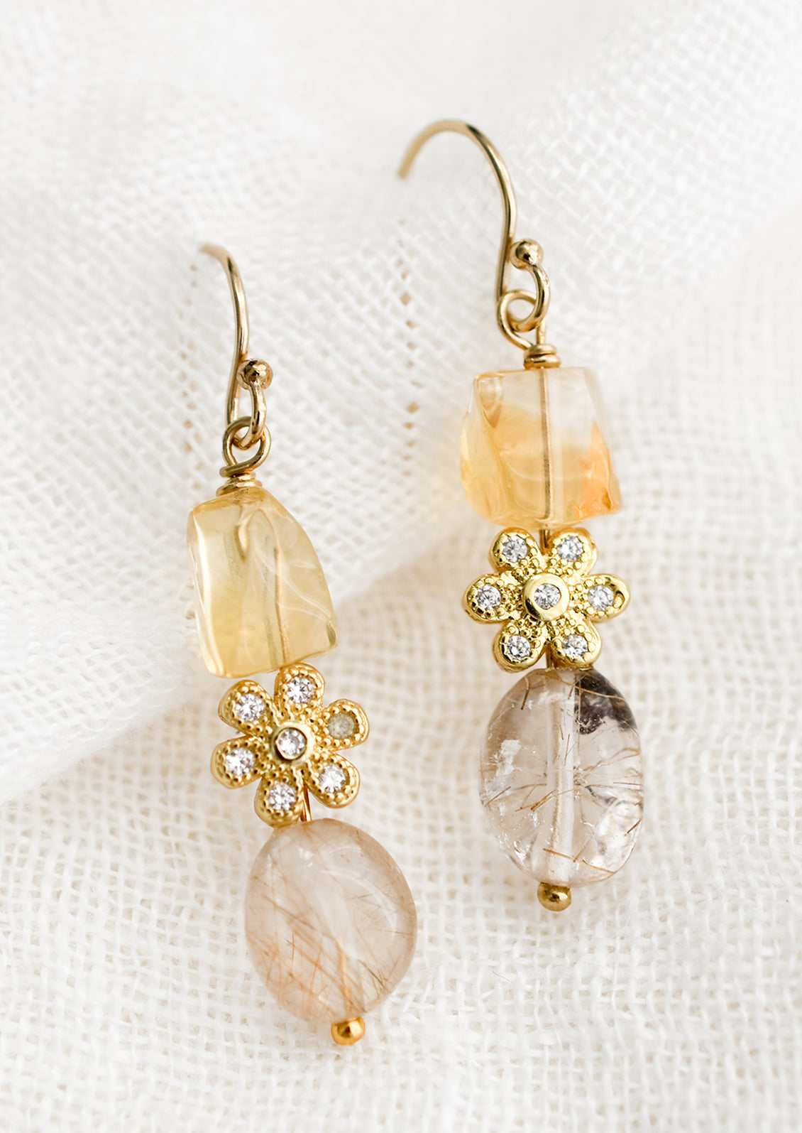 A pair of beaded drop earrings with rose quartz and citrine stones, and crystal flower detail.