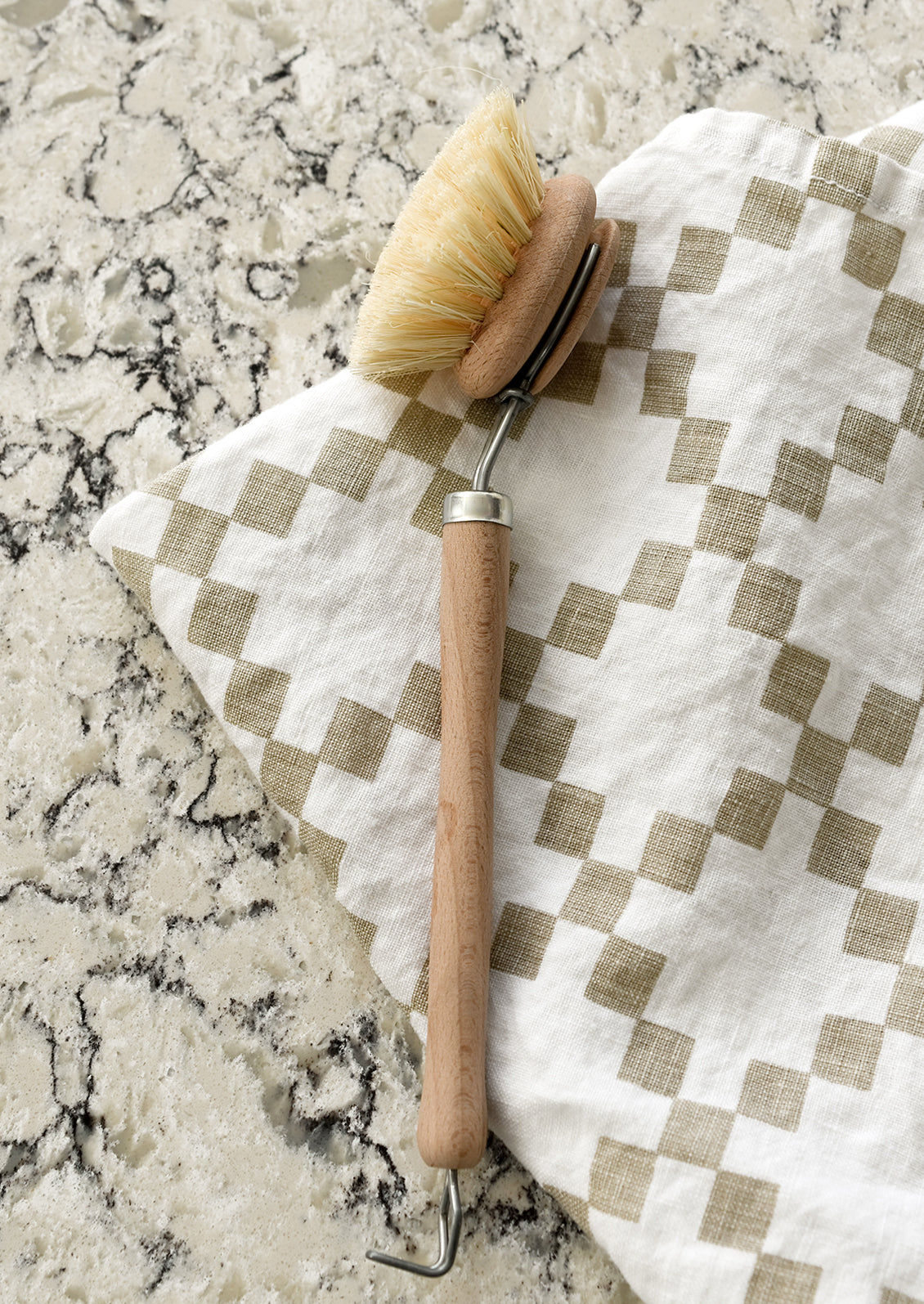A beech wood cleaning brush on a kitchen counter.