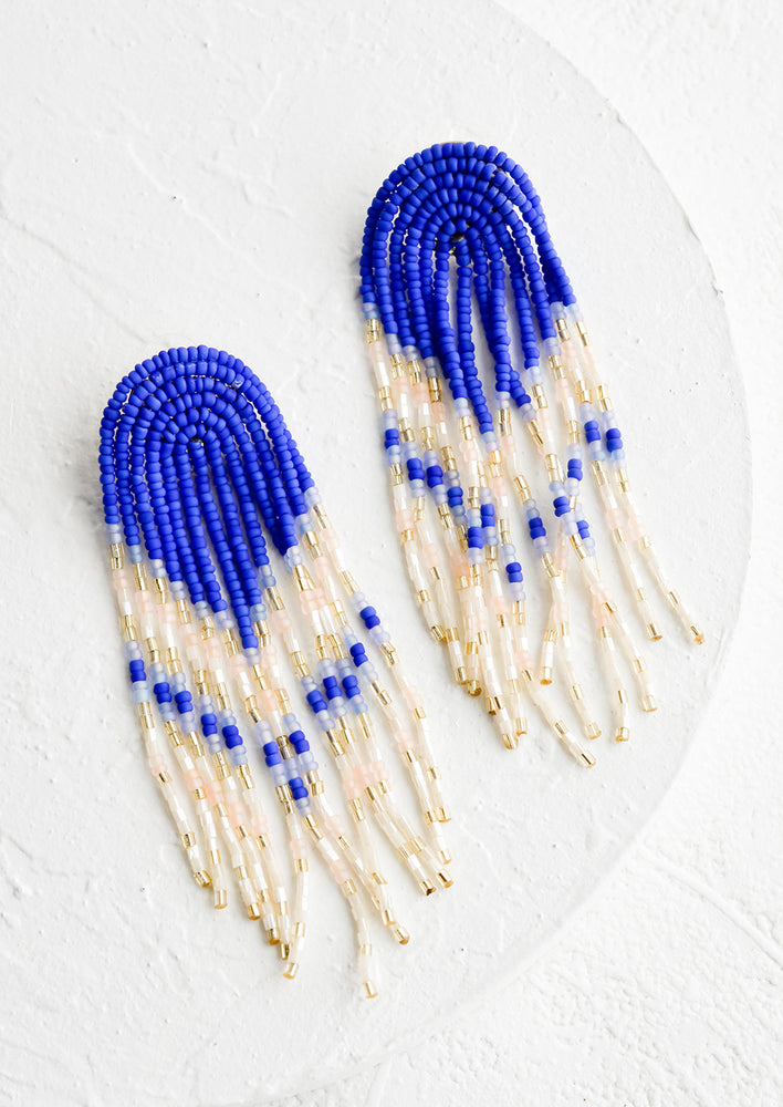 1: A pair of beaded earrings with arched top and fringed strands.