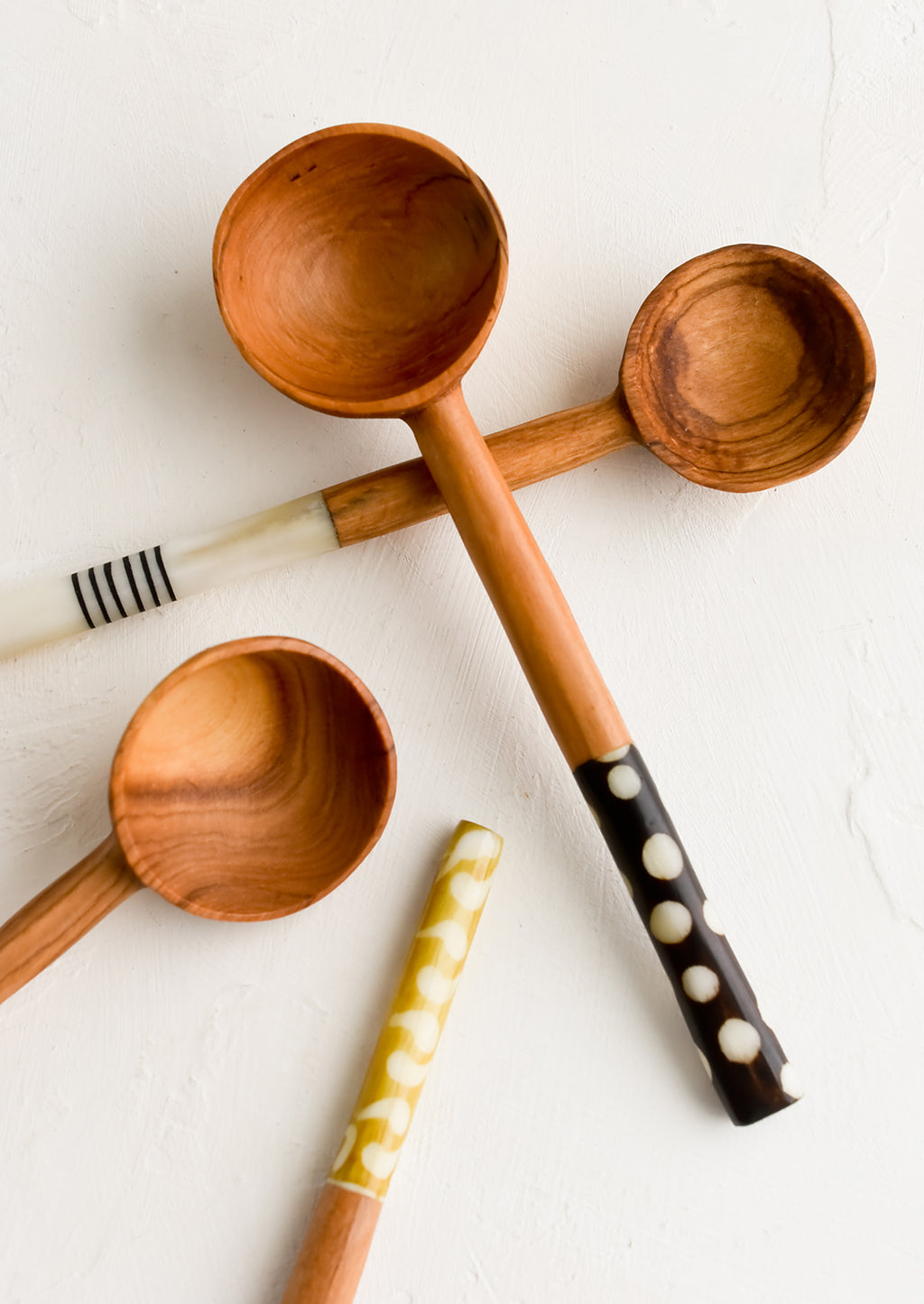 1: Assorted olivewood coffee scoops with decorative bone handles.