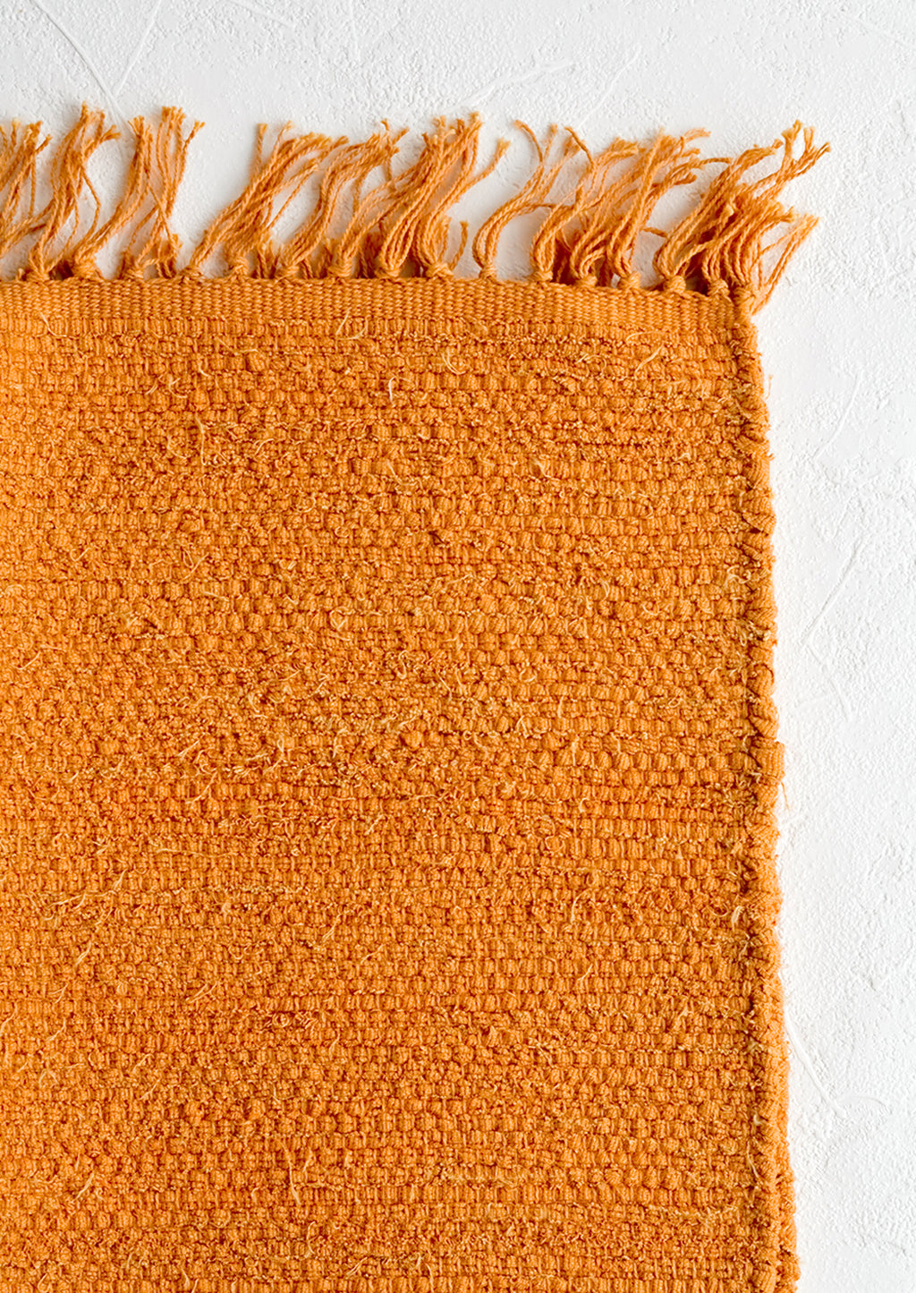 Goldenrod: A textured cotton rug in orange rust.