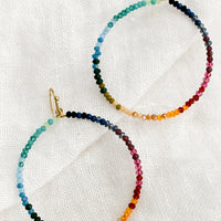 Rainbow Multi: A pair of beaded hoop earrings in gradient rainbow colors.