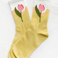 Sun Yellow: A pair of socks in yellow with pink tulip design at ankle.