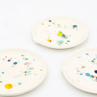 2: Three ceramic spoon rests in ivory with splattered colorful glaze drips.