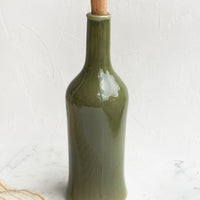 Tall / Olive Gloss: A glossy olive colored tall bottle with cork top