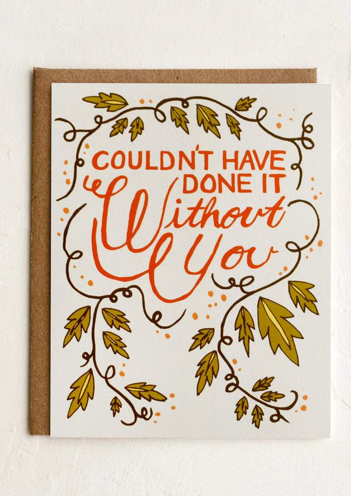 A greeting card with red lettering reading "Couldn't have done it without you".