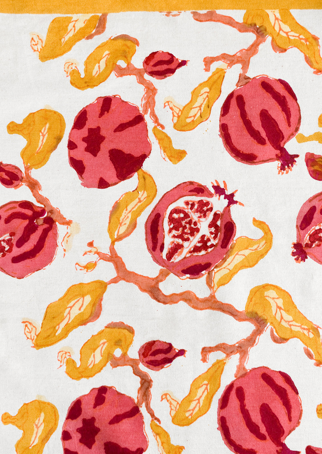 A block printed pomegranate pattern in red, pink and yellow.