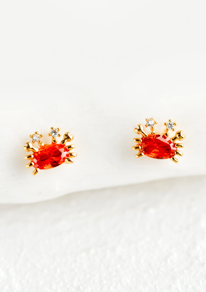 1: A pair of small stud earrings in the shape of crabs.