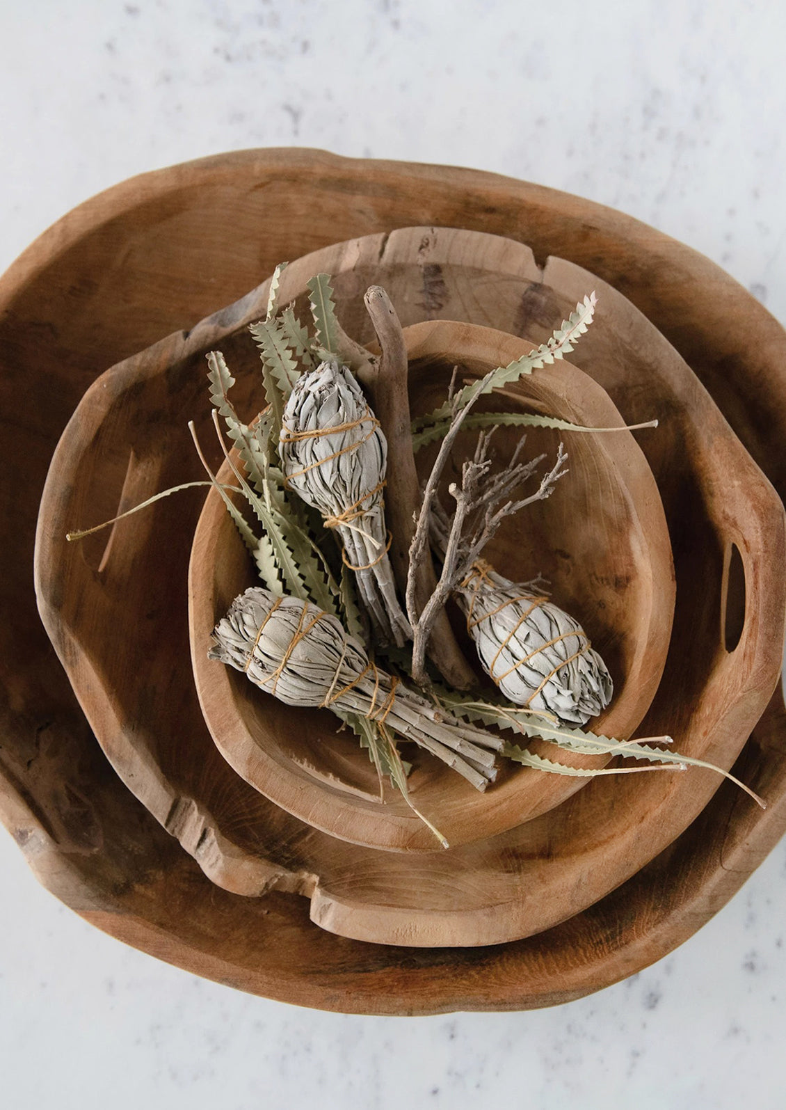 Teakwood bowls with sage bundles.