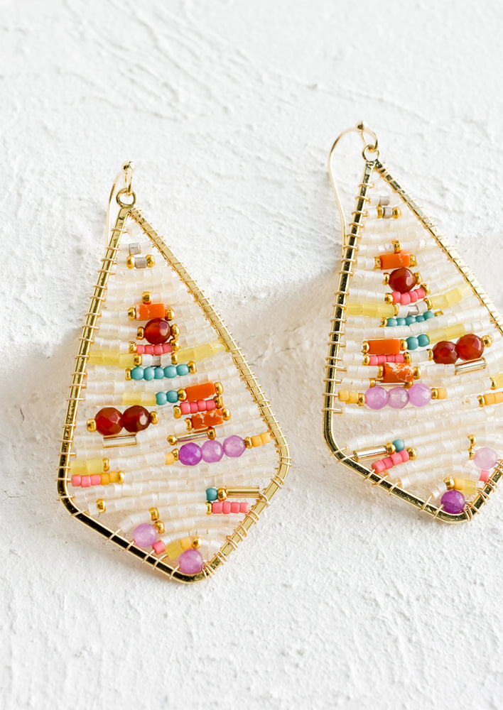 1: A pair of beaded earrings in teardrop frame.