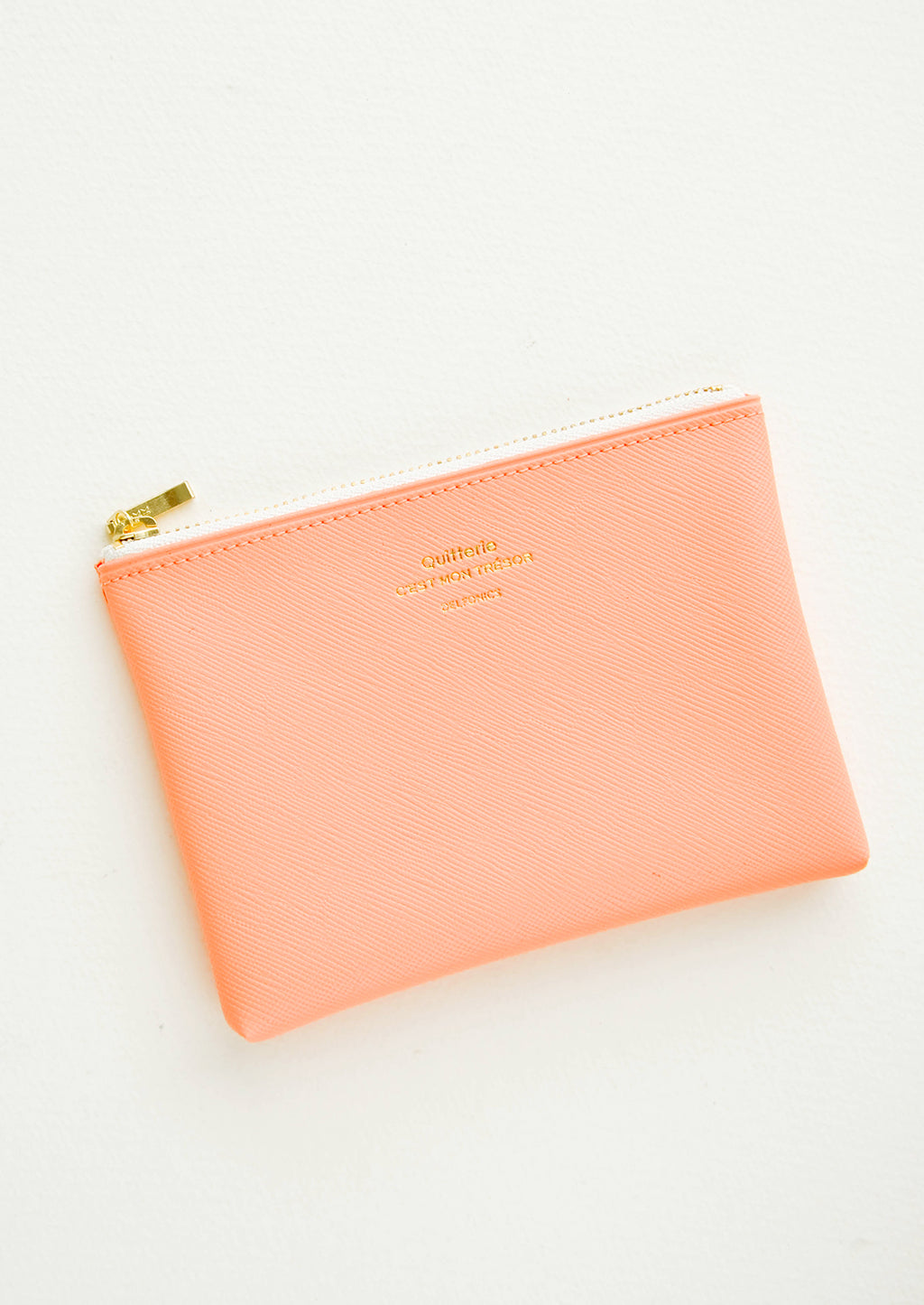 Peach / Small: Small vinyl coin pouch with gold zipper and crosshatch texture, in peach.