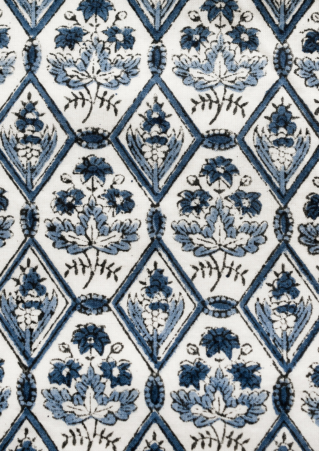 2: A block printed pillow in blue and white tile print.