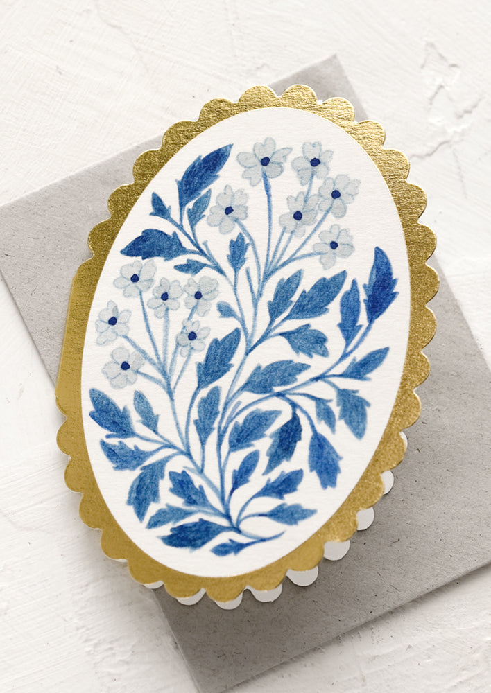 1: A blue floral print card with diecut oval shape and scalloped edges.