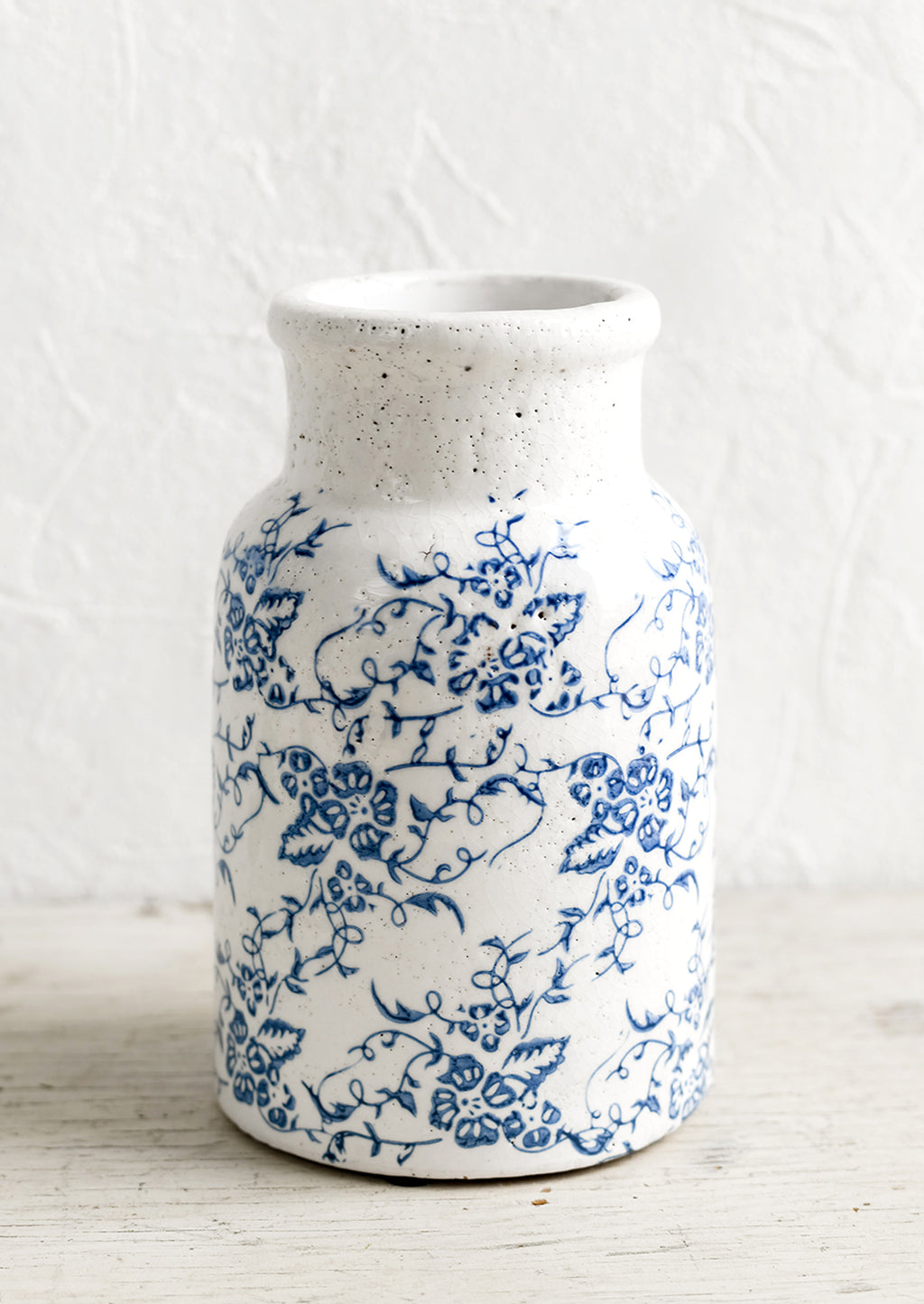 1: A blue and white ceramic vase with antique floral print.