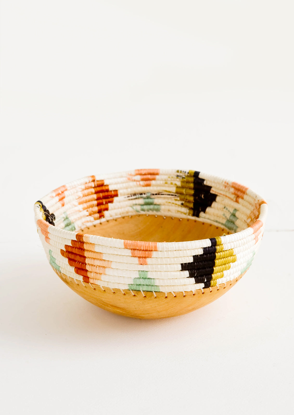 Decorative bowl with wooden basin and woven rim featuring multicolor triangle print