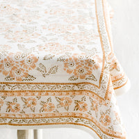 2: A block printed tablecloth with peach and brown floral print.