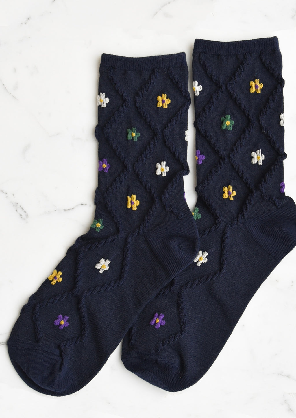 Navy Multi: A pair of navy socks with diamond pattern and florals.