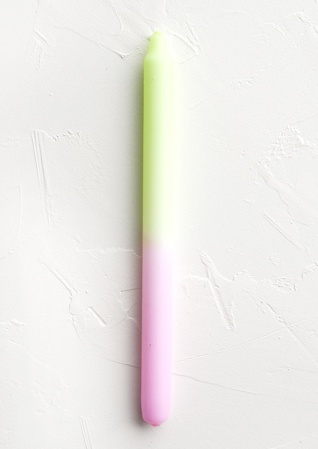 Neon Yellow / Pink: A straight taper candle in neon yellow and pink.