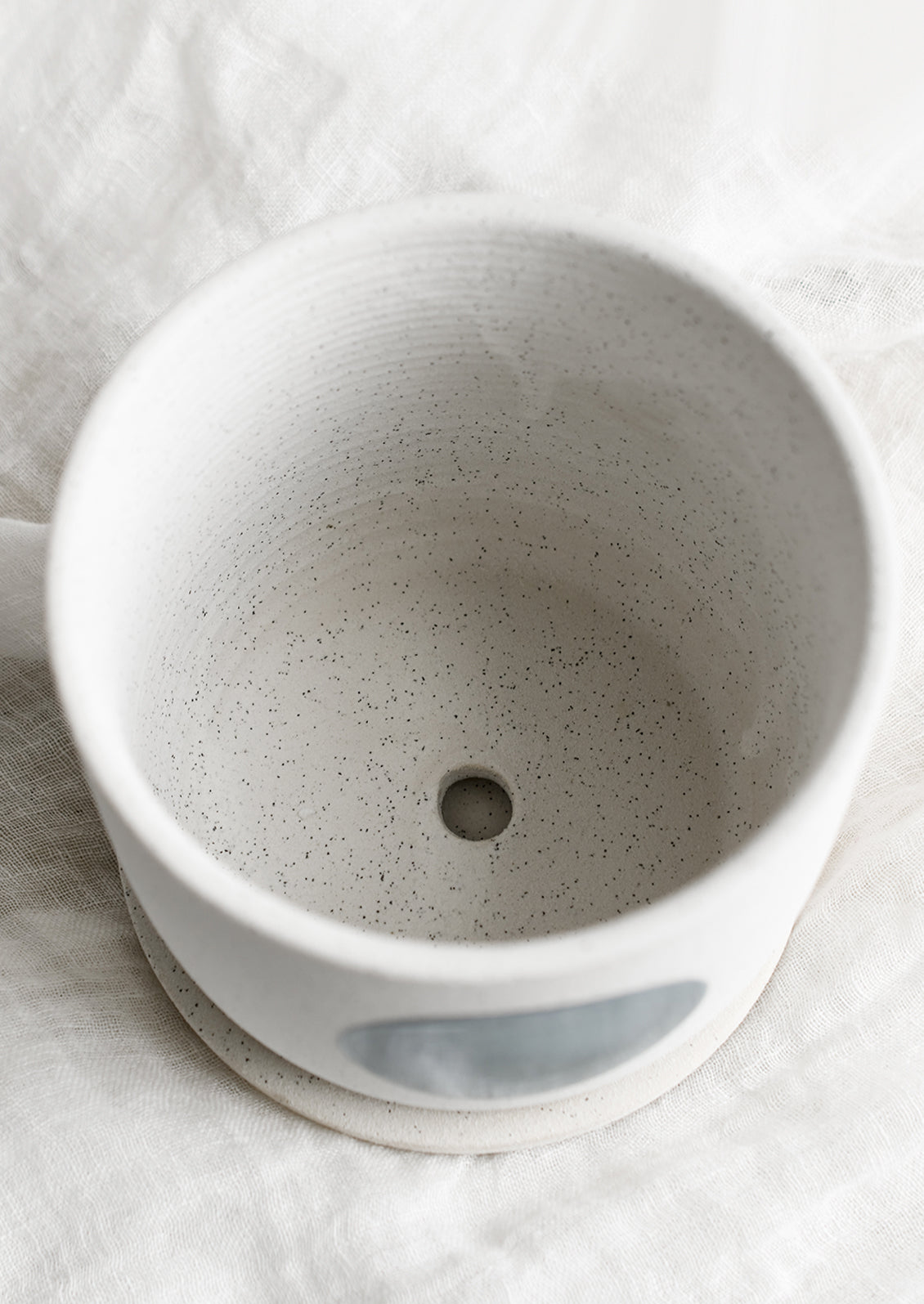 A planter showing bottom drainage hole.