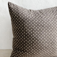 1: A square block printed throw pillow in dark grey with white dot-cross motif.