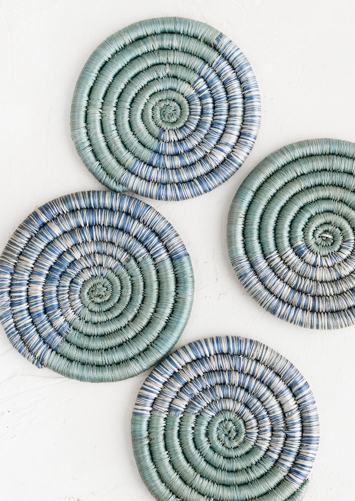 1: A set of four round coasters in blue spacedye weave.