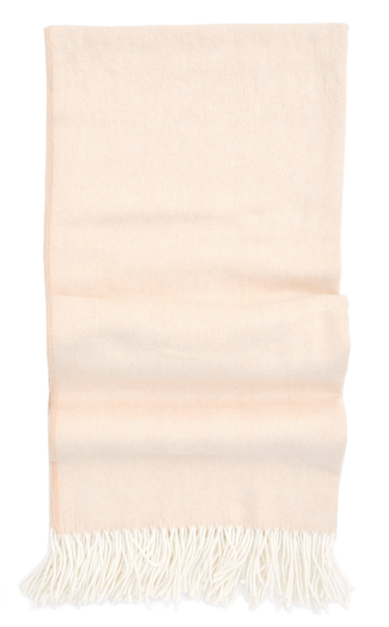Tan colored throw blanket in fine herringbone weave and ivory tassel trim