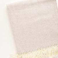 Latte: Soft throw blanket in fine herringbone weave and ivory tassel trim. Soft tan color.