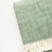 Olive: Green throw blanket in fine herringbone weave and ivory tassel trim