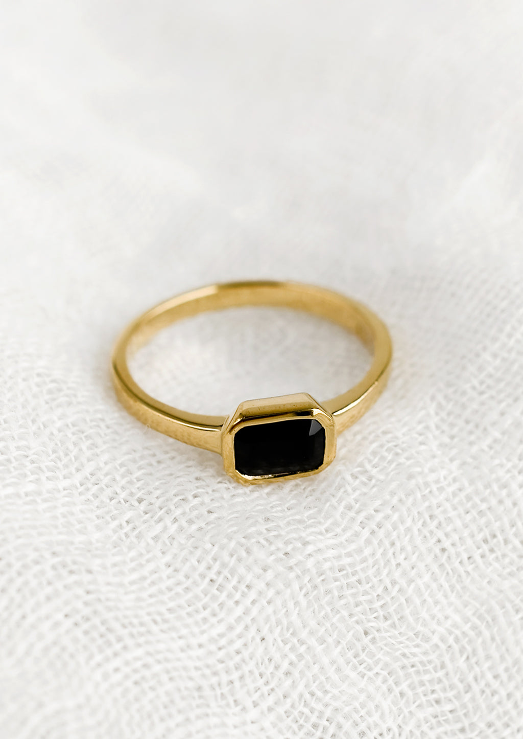 Size 6 / Onyx: An emerald cut gold ring with onyx stone.