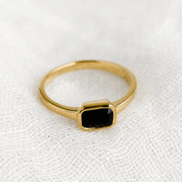Size 6 / Onyx: An emerald cut gold ring with onyx stone.