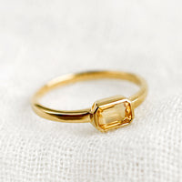 Size 6 / Citrine: An emerald cut gold ring with citrine stone.